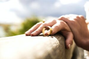 hand with wedding ring coming off