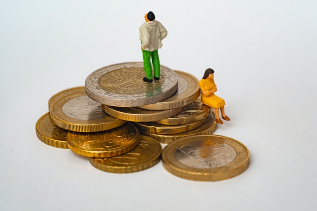 man and woman sitting on giant money