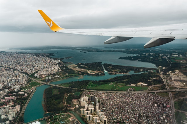 plane flying across city